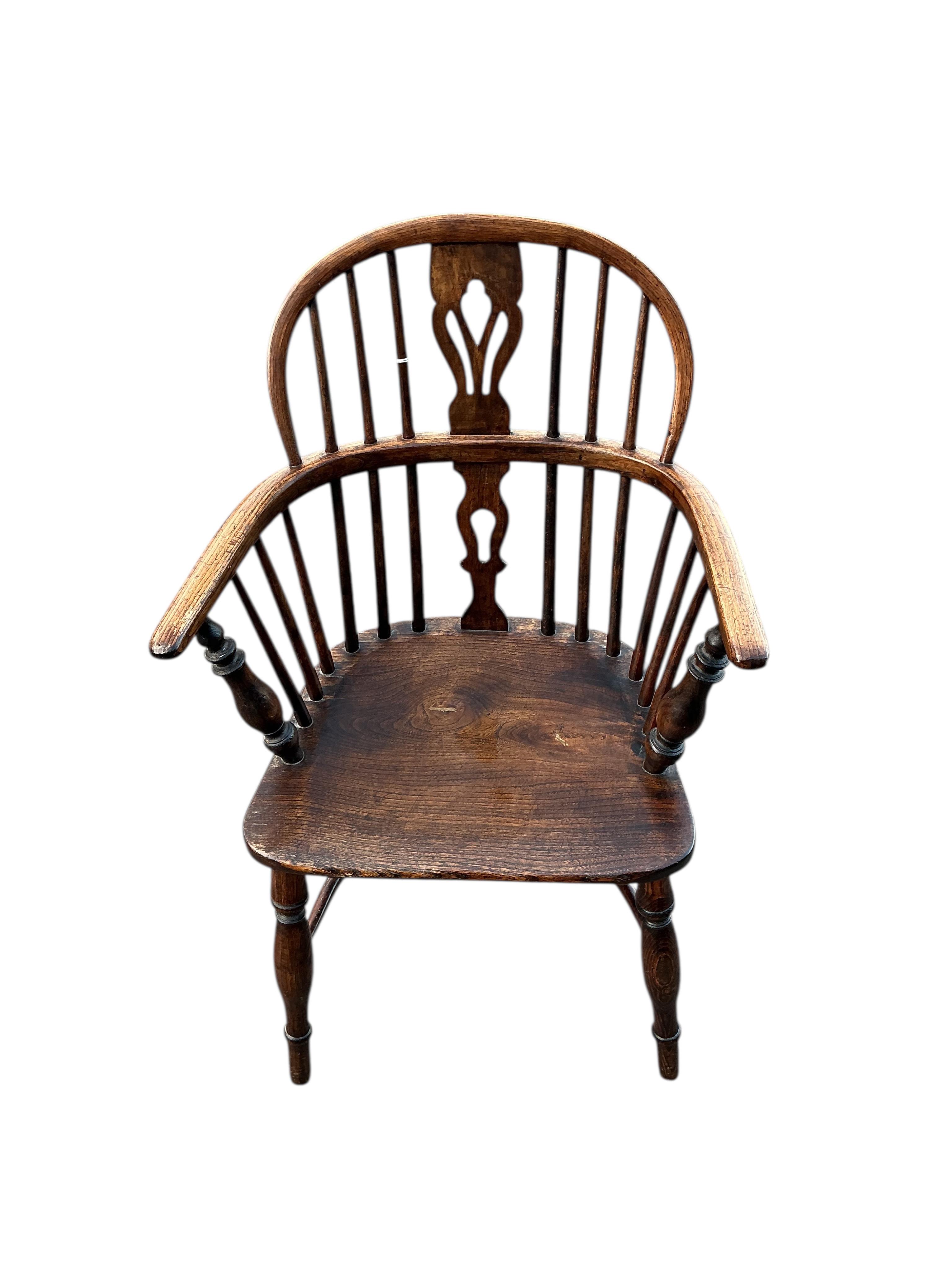 A 19th century Windsor ash and elm elbow chair with crinoline stretcher, width 57cm, depth 38cm, height 91cm